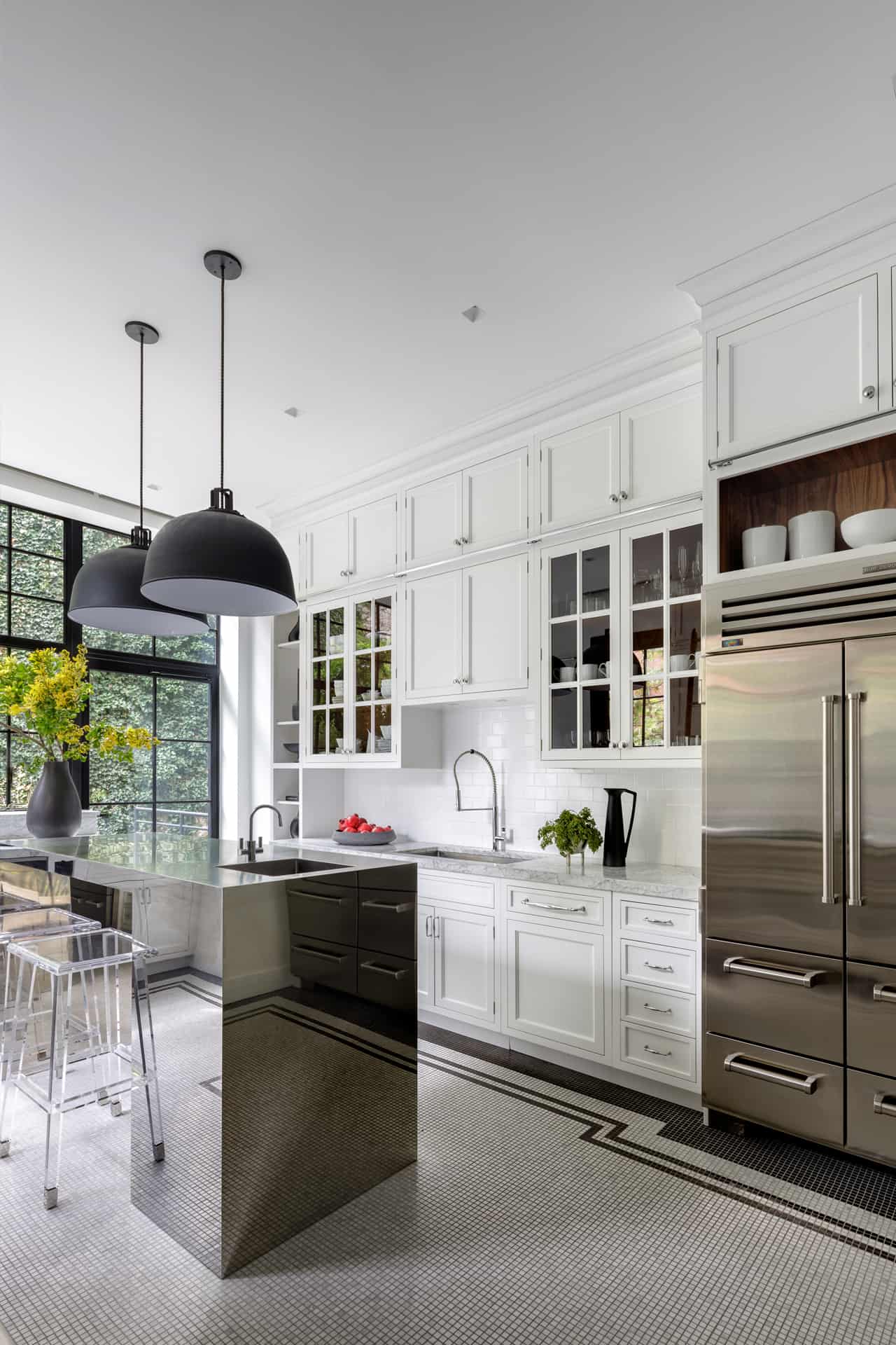 Art Deco inspired kitchen features white Bilotta cabinets with honed black granite countertops and a black island with polished white Caesarstone top.