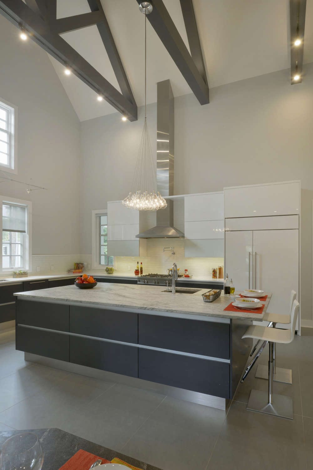 Base cabinets, center island and breakfast nook of contemporary kitchen feature alumasteel accents and toe kick.