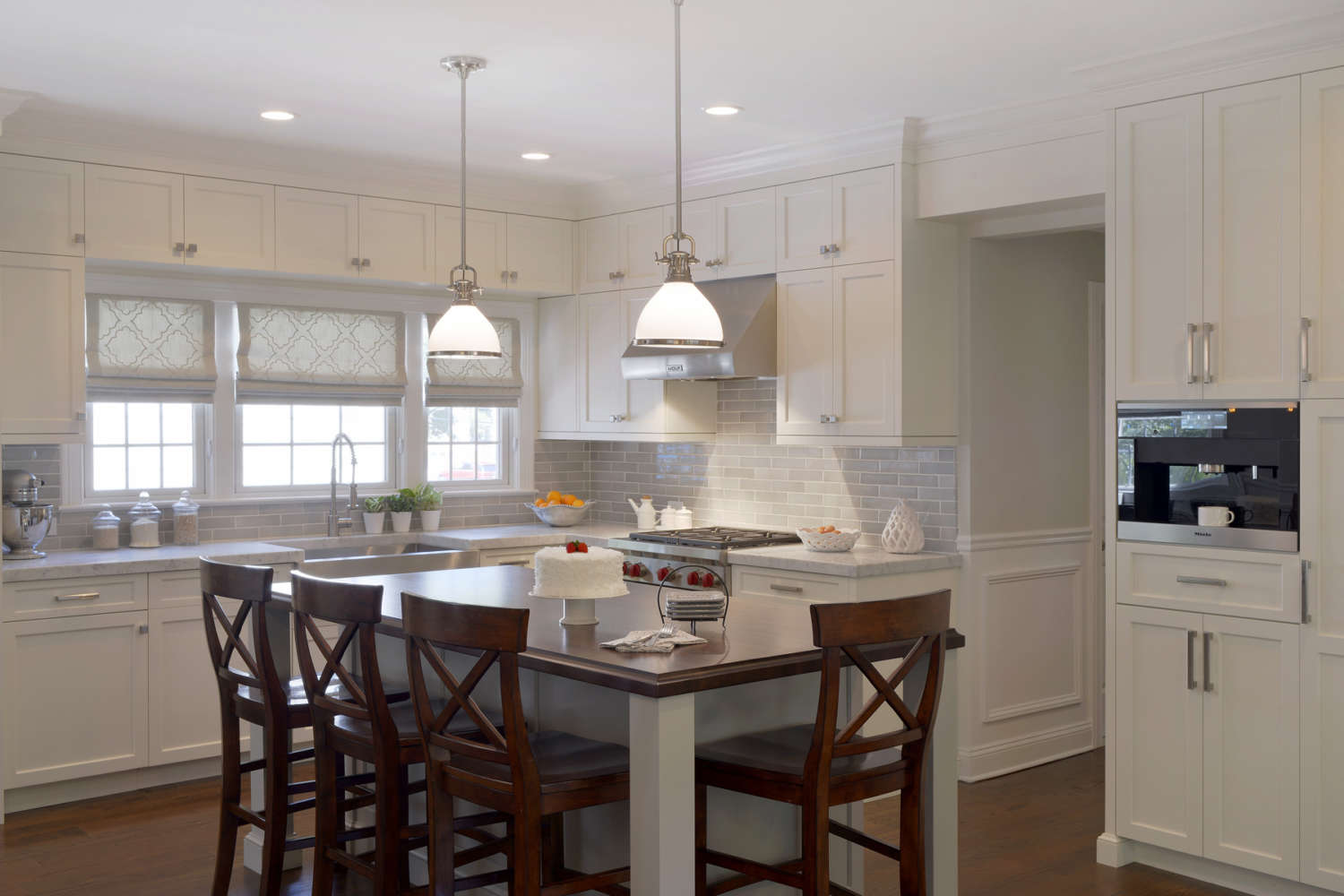 Classic kitchen features Dove White Bilotta Signature cabinetry and mahogany topped island and coffee station.