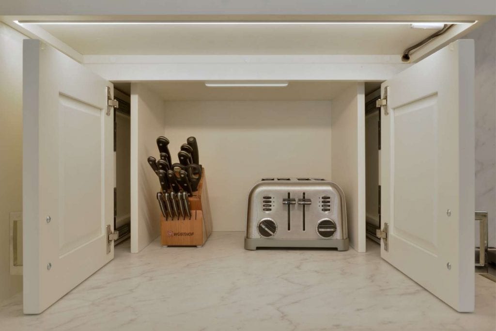 Appliance garage conceals toaster and knife set.