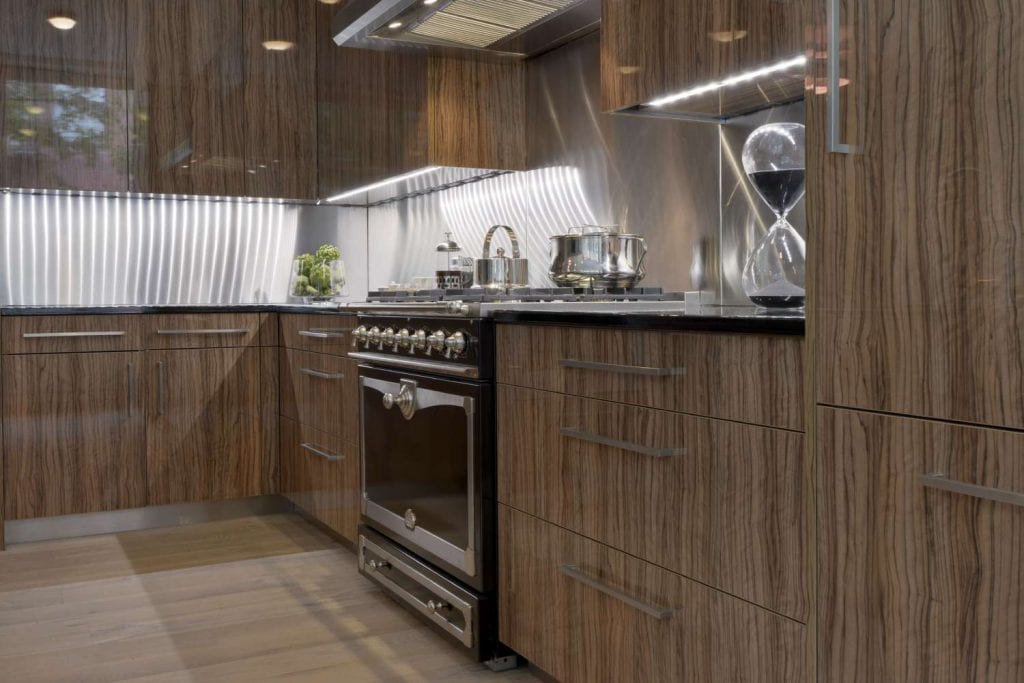 Kitchen features custom cabinetry with high gloss lacquer finish and LED under-counter lighting.