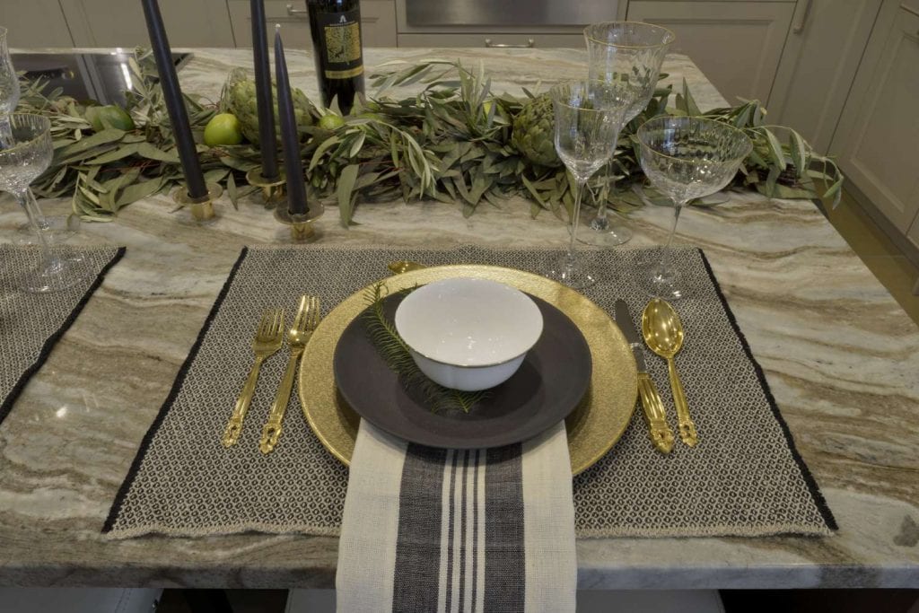 Table features garland comprised of seeded eucalyptus, olive branches, artichokes and limes, crafted by Stacey Neylan of Winston Flowers