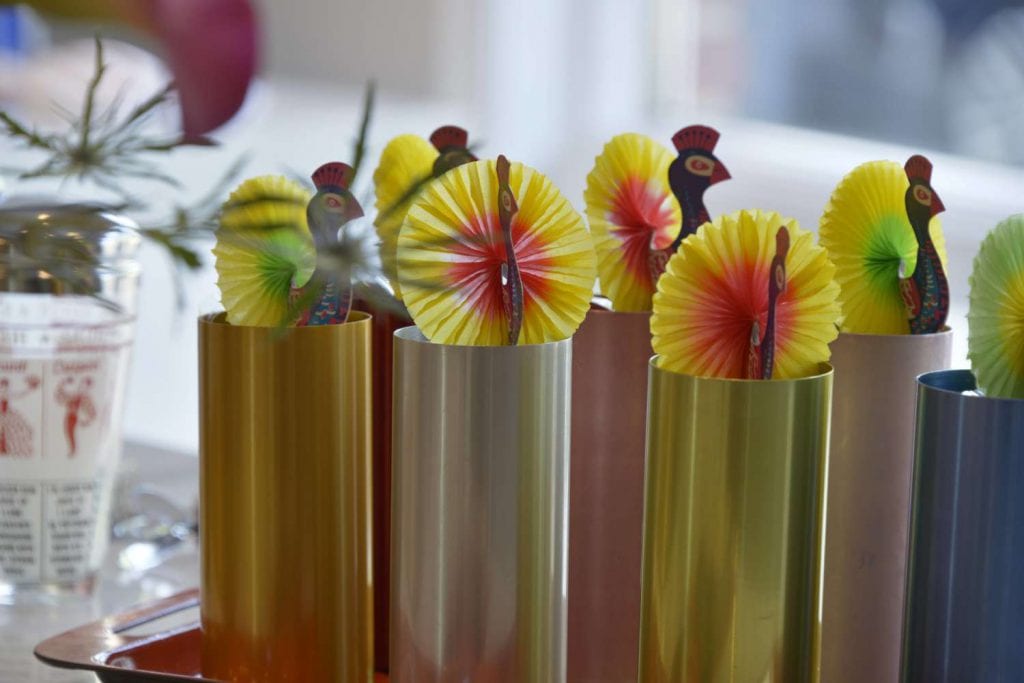 Close-up of iconic 50’s colored aluminum tumblers from Penthouse Cocktail Party themed tablescape.