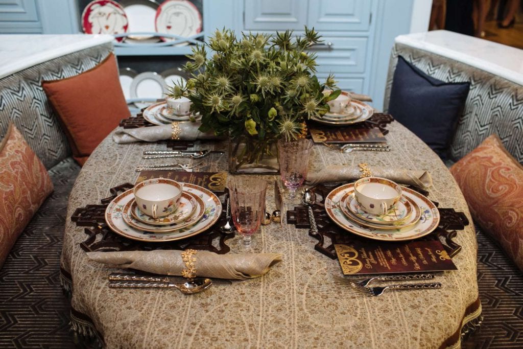 Oval table set with embroidered table cloth and Herend China on wood place mats