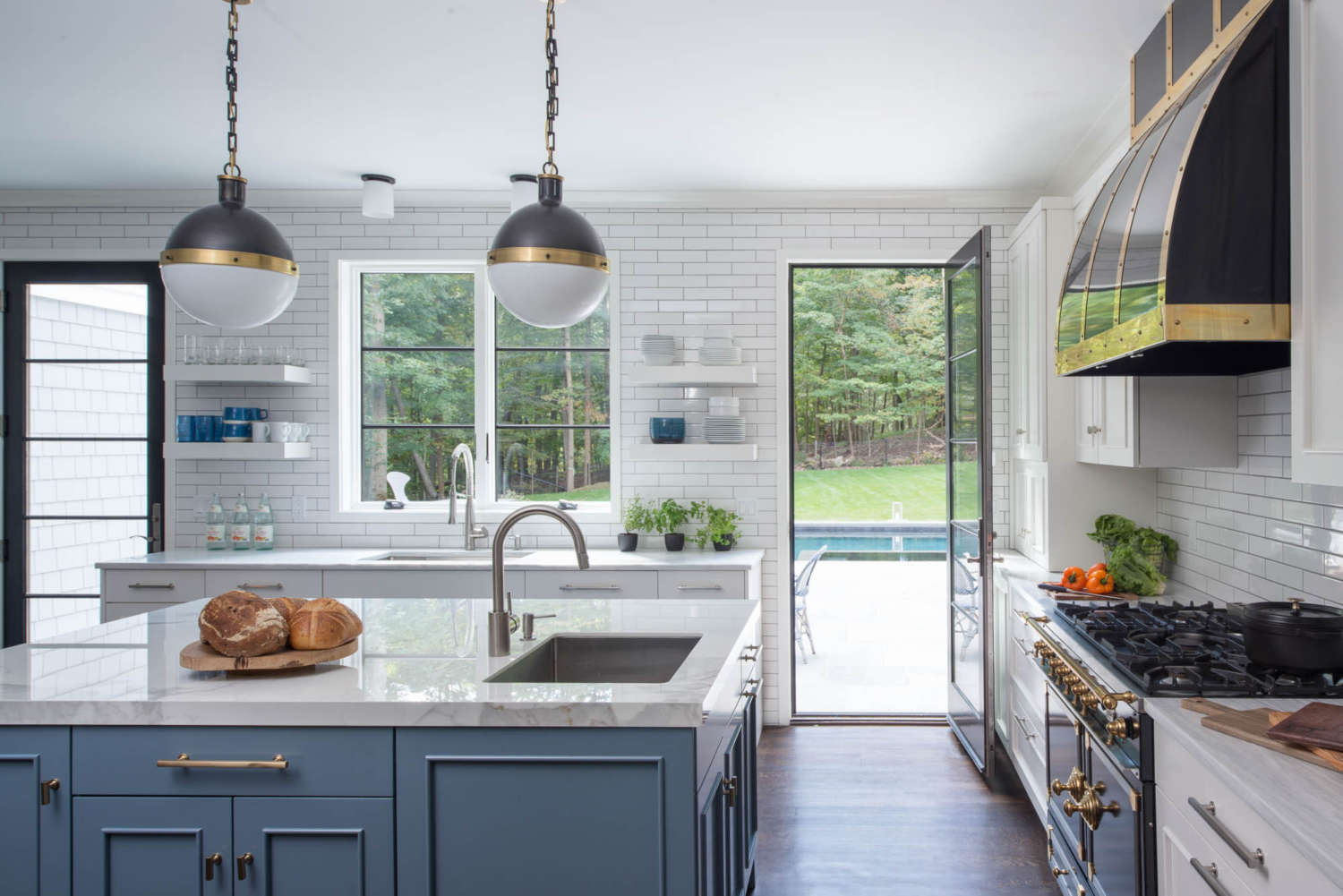 White kitchen gets a pop of color from a Benjamin Moore Blue Toile painted center island.