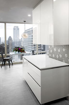 NY high-rise modern minimalist kitchen with white glossy Artcraft cabinets. Design by Daniel Popescu of Bilotta Kitchens in collaboration with Gurri NY Design + Remodel.
