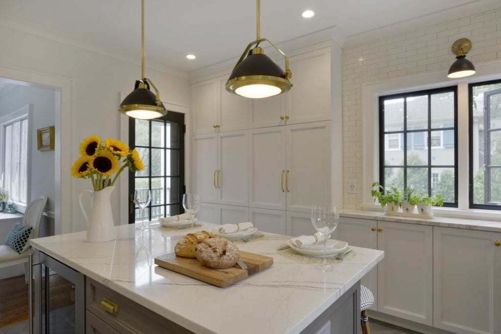 Classic White Kitchen with brass hardware and black and brass island lighting
