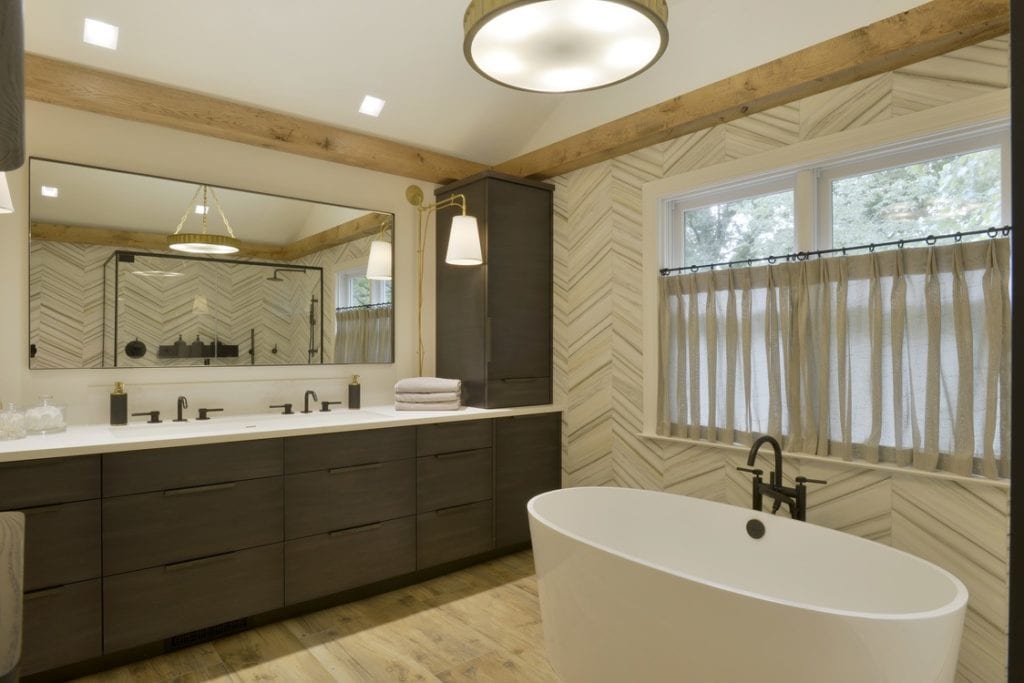 Contemporary Bathroom with dark wood vanity and chevron patterned wall tile.