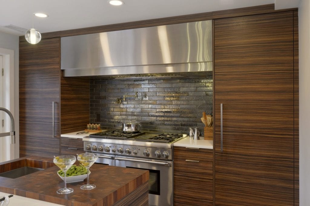 Contemporary Kitchen Hearth with Stainless Hood and metallic tile backsplash