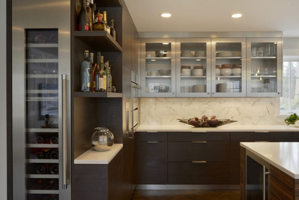 Contemporary Kitchen in Zebrawood & Stainless, with glass-front upper cabinets.