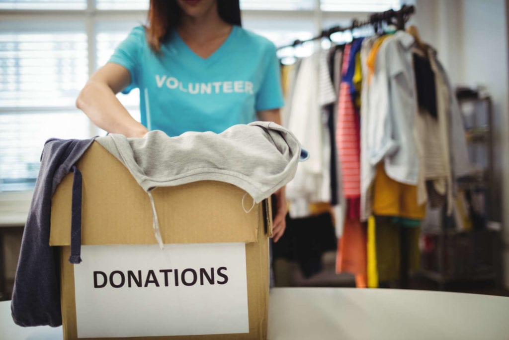Volunteer Sorting through Donated Clothes