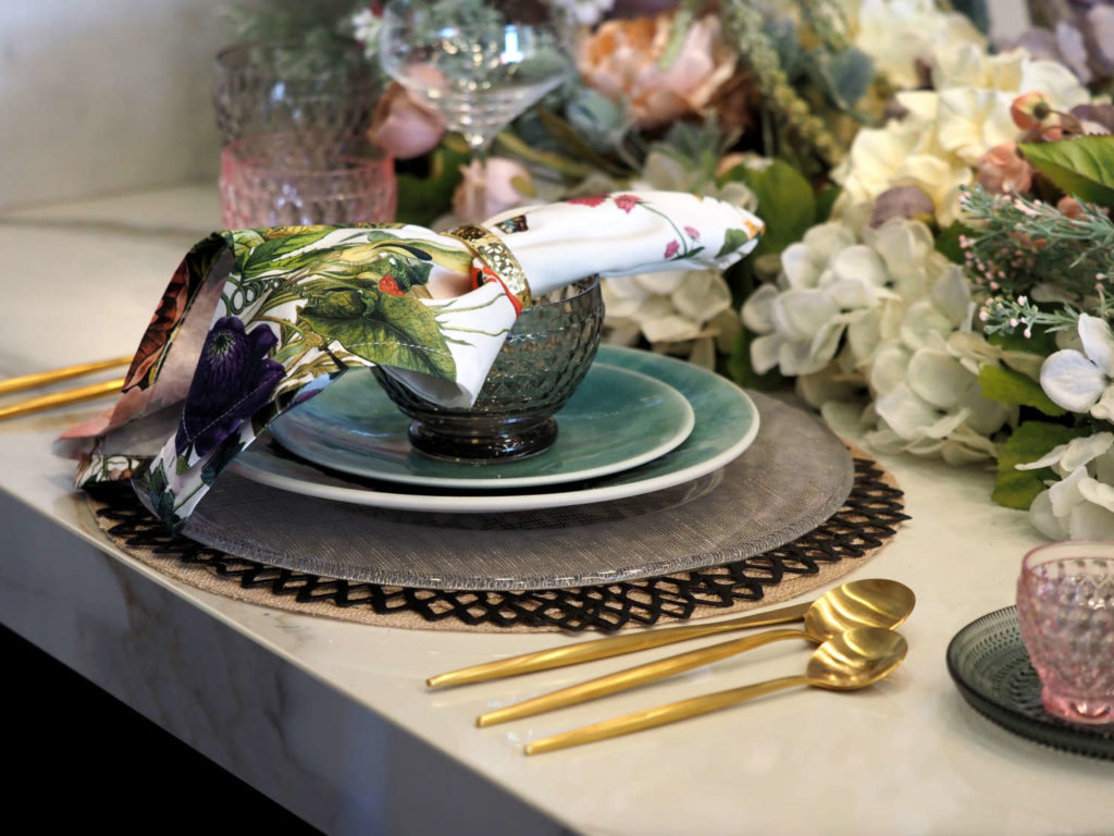 Place Setting by Alexandra Amirian, featuring Chilewich's black “Pressed Dahlia” openwork placemat