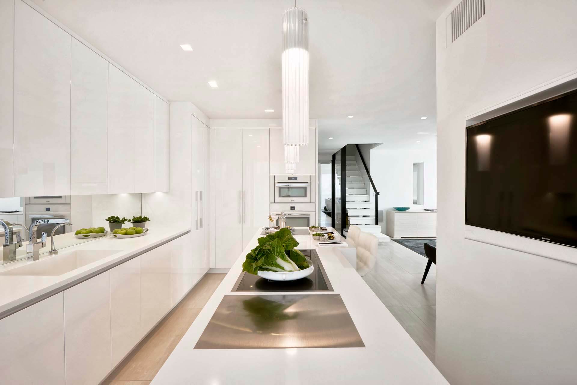 Contemporary high-gloss, all white kitchen with Artcraft cabinets in an Upper East Side Manhattan loft.