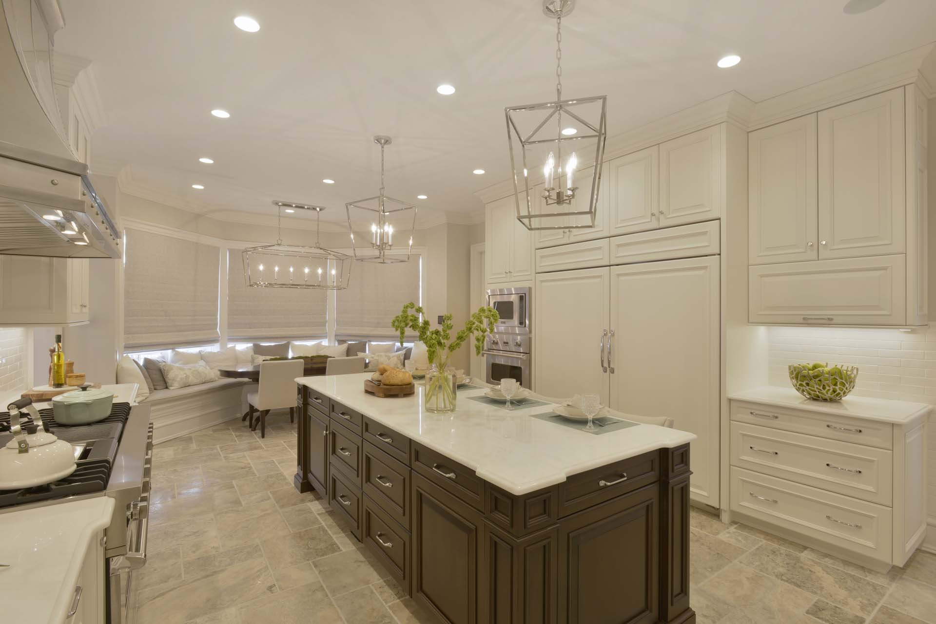 Classic kitchen features white painted Bilotta cabinetry and marble-topped cherry stained island.
