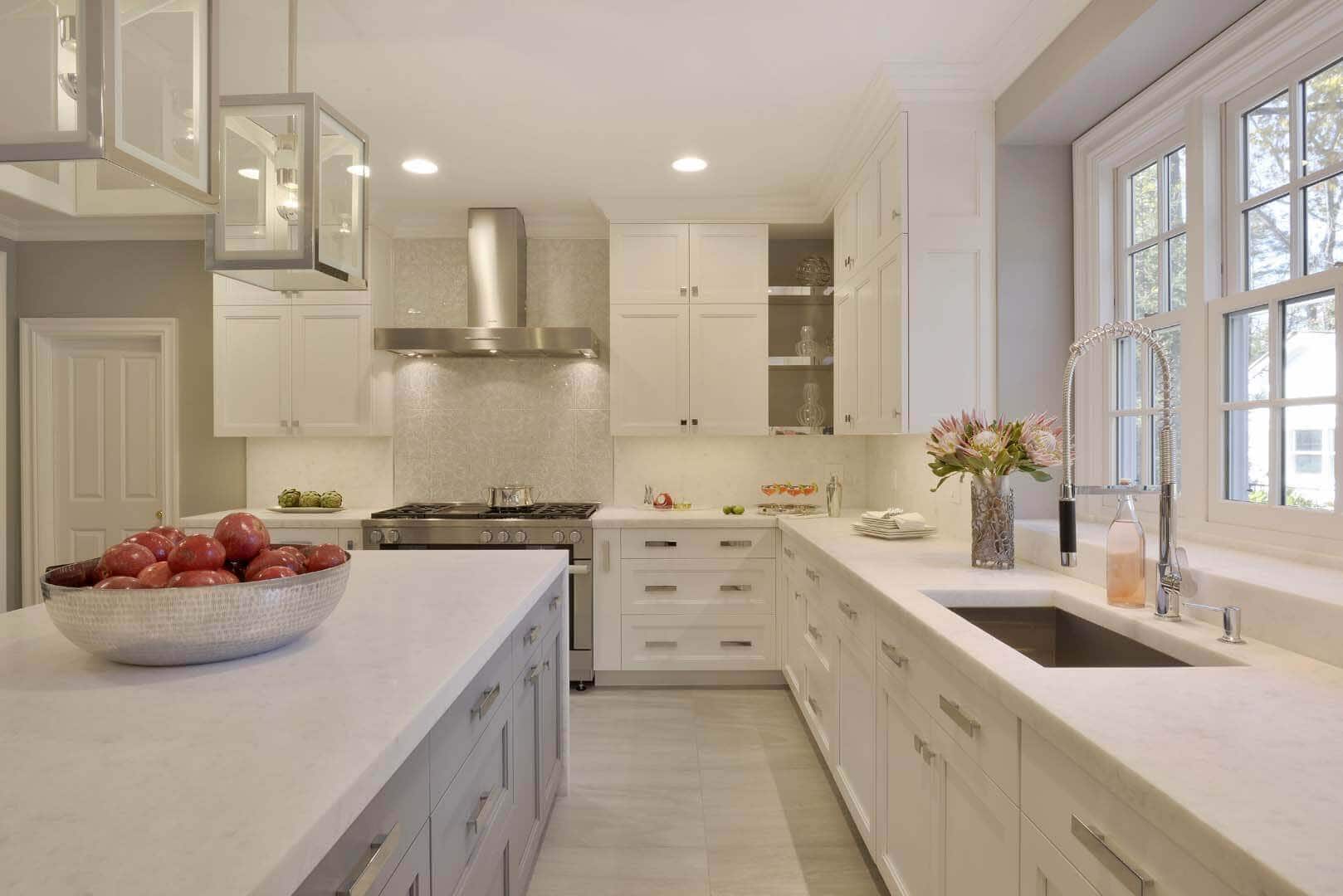 Classic kitchen features white Bilotta cabinetry and island, white diamond marble countertop and Stone Fox backsplash.