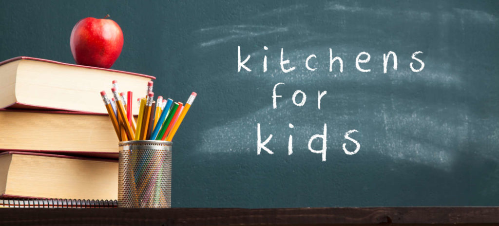 "Kitchens for Kids" written on chalkboard