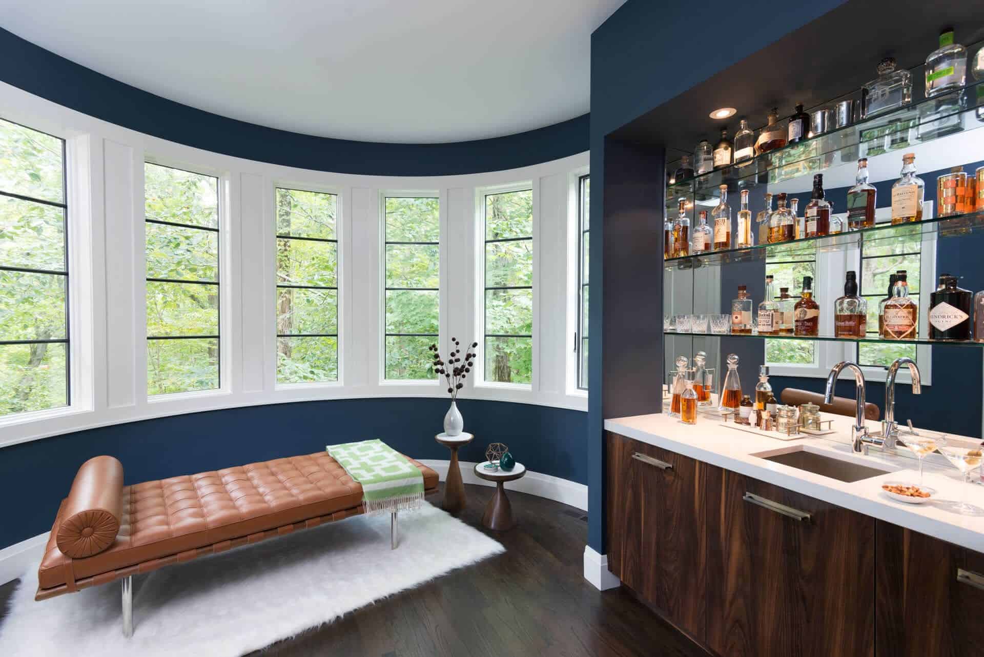 Dark blue windowed room featured natural walnut Bilotta custom mid-century modern bar.