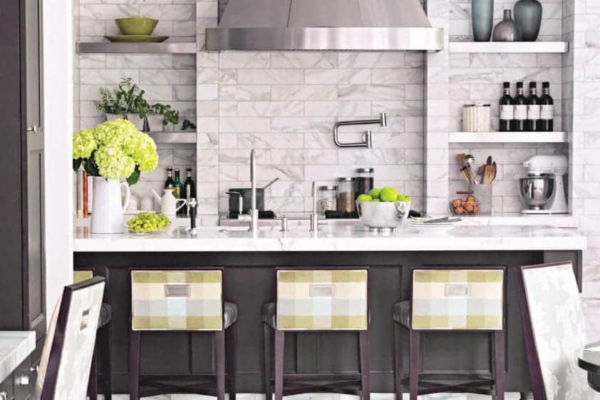 Statement making kitchen features honed marble brick on walls and Vestige Ash chevron patterned limestone flooring.