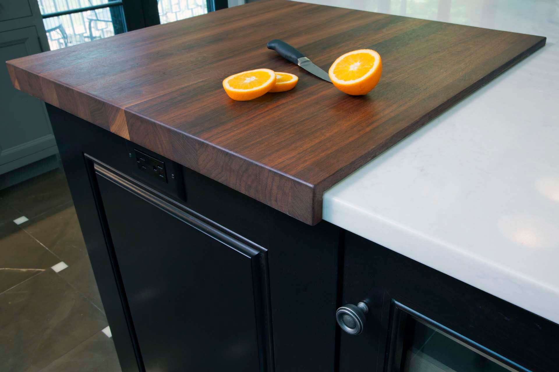 Cherry butcher block integrated into Caesarstone topped cherry wood island with Black Forest finish.