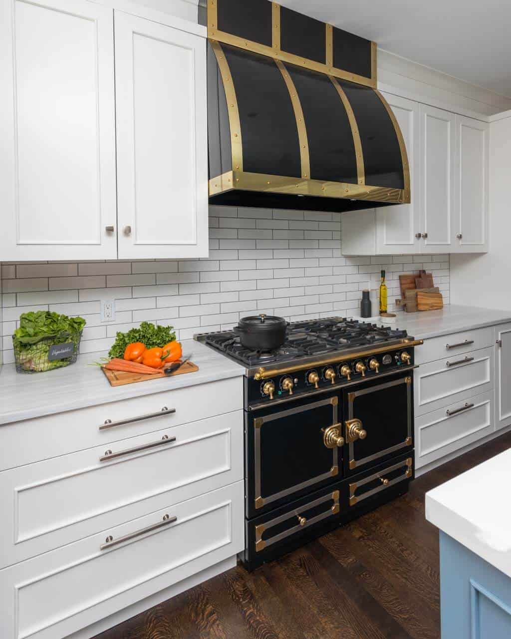 Classic Pleasantville NY kitchen features Bilotta custom cabinets, chrome and brass hardware and black and brass La Cornue range and hood.