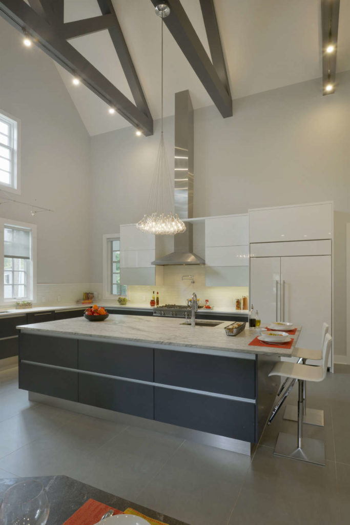 Contemporary Kitchen with vaulted ceiling features lit exposed beams