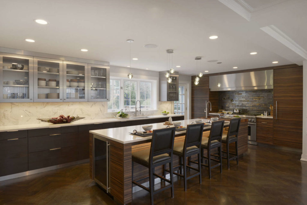 Contemporary kitchen features Artcraft cabinetry with built-in features for entertaining and cooking.