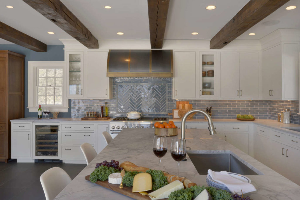 Traditional White & Oak Kitchen with Wood Ceiling Beams and custom stainless and brass hood