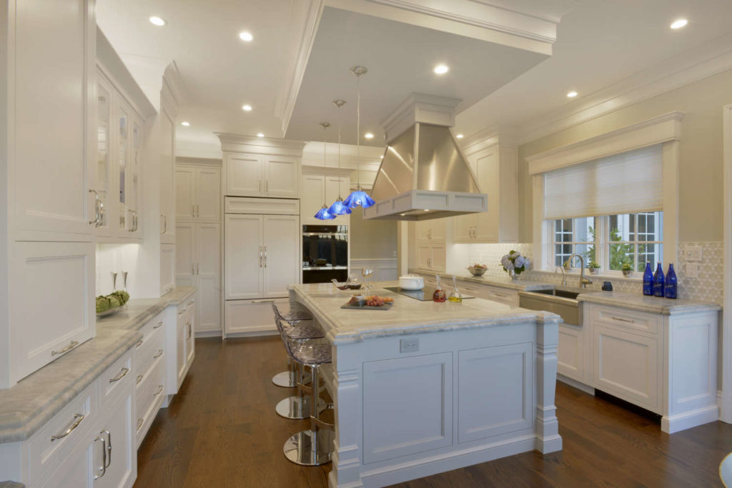 Traditional White Kitchen features blue pendant lights