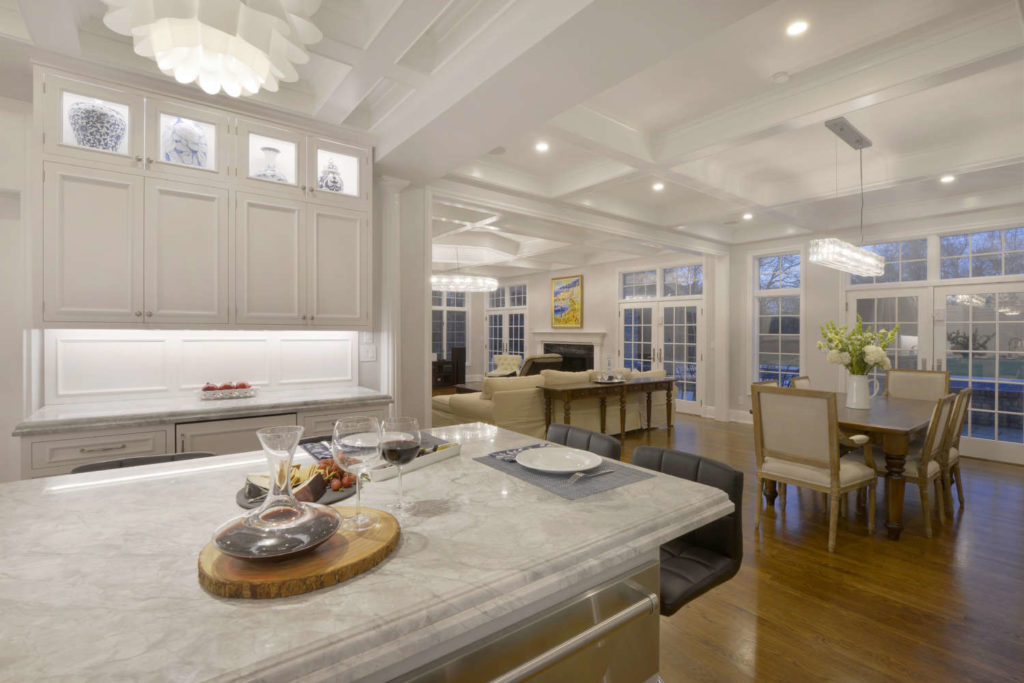 Traditional expansive white kitchen with coffered ceiling