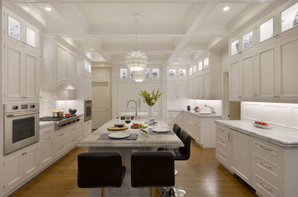 Traditional White Kitchen with coffered ceiling and lit display upper cabinets