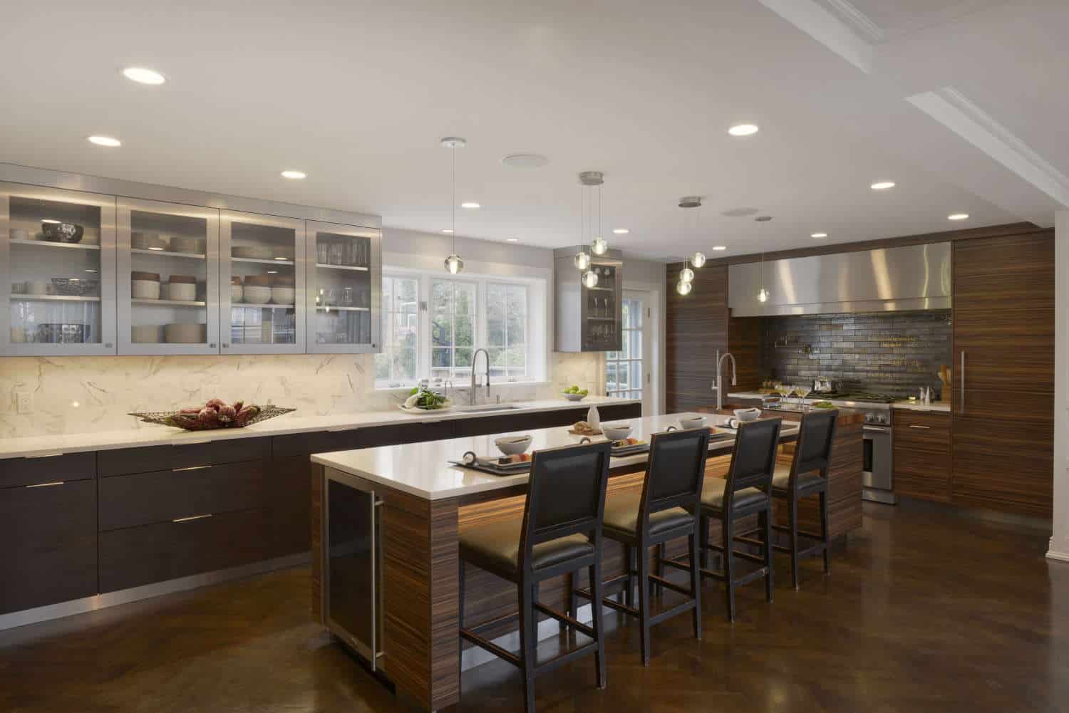 Contemporary kitchen mixes Monza HP Alumasteel upper cabinets with natural walnut topped horizontal-grained dark wood veneer island.