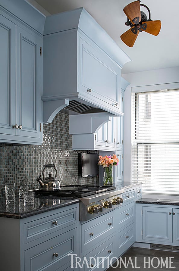 Blue Bilotta kitchen with granite countertop and tile backsplash.