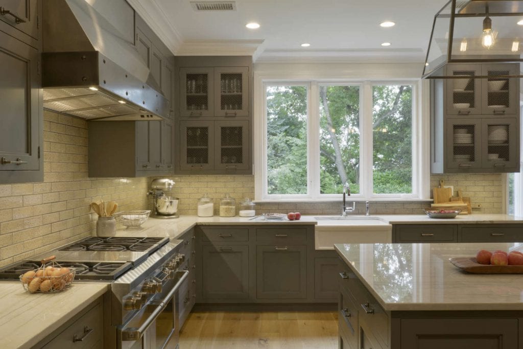 Classic country kitchen features White Macambas Caesarstone topped grey Bilotta island and adjacent custom wood table.