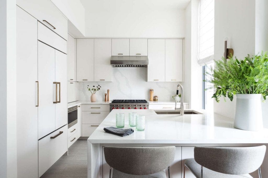 Contemporary all-white Bilotta loft kitchen features durable, easy to clean, low maintenance materials.