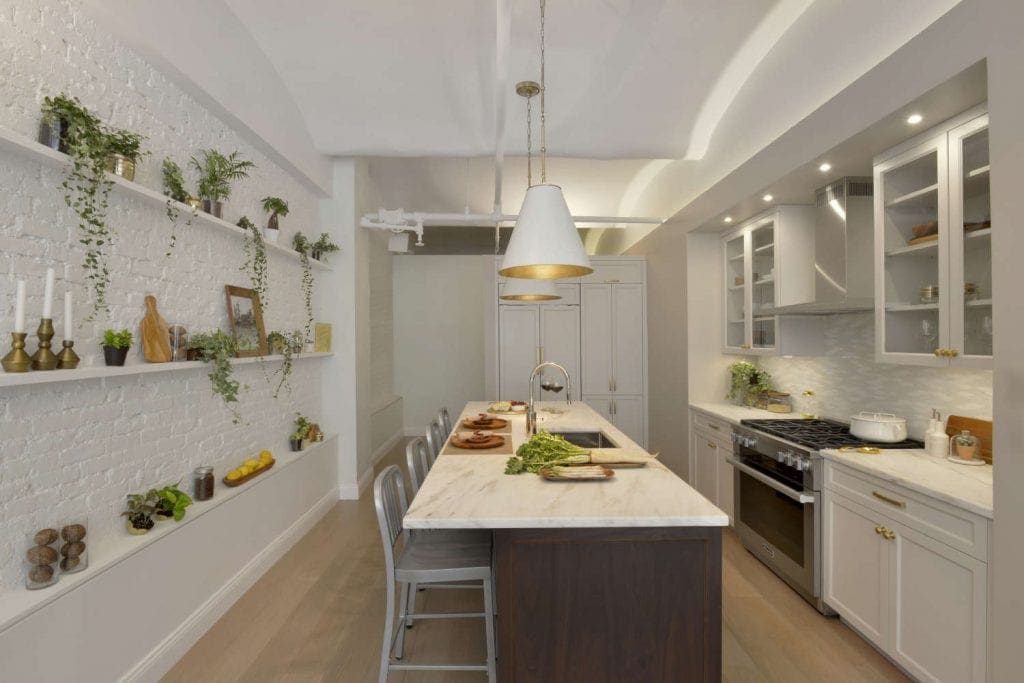 NYC loft kitchen features Bilotta cabinets in Balboa Mist and Jazz Glass mosaic backsplash.