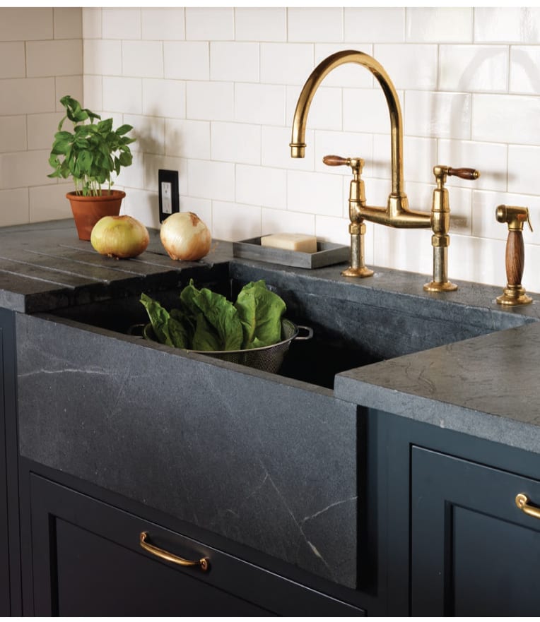 Soapstone sink with brass faucet.