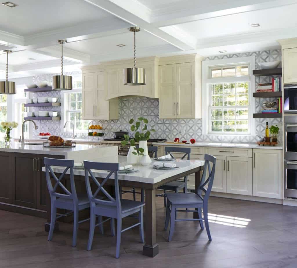 Eat-in area of kitchen features a versatile freestanding table designed to look like an extension of the island.