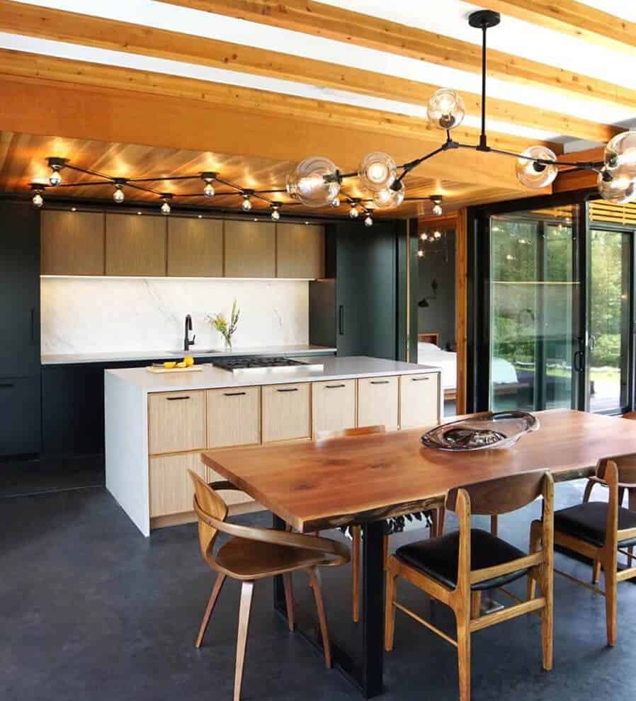 Mid-century modern kitchen features natural heart pine ceiling planks and walnut quarter-sawn veneer cabinetry.