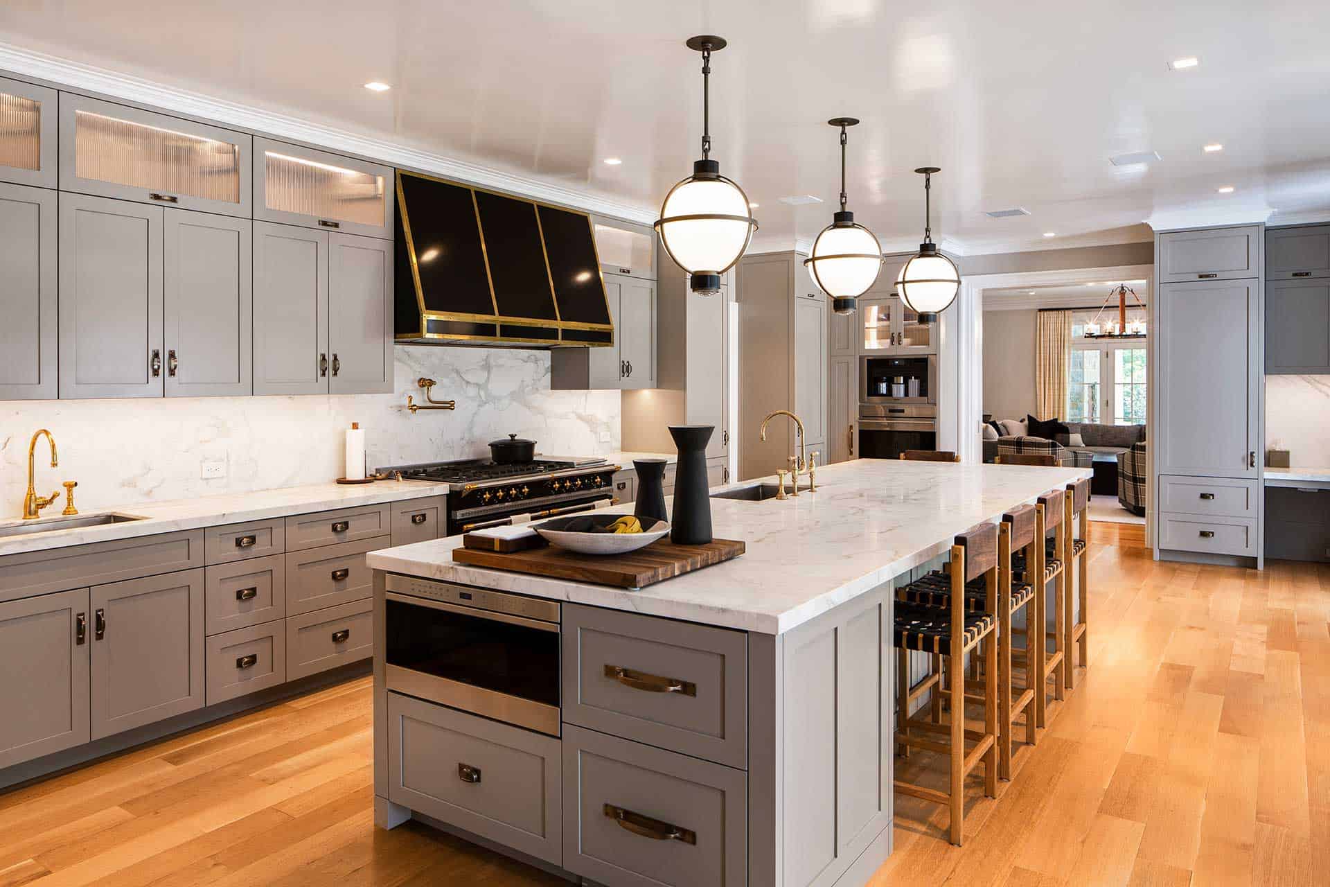 European kitchen features gray painted Bilotta custom cabinetry, black and gold La Cornue range and hood.