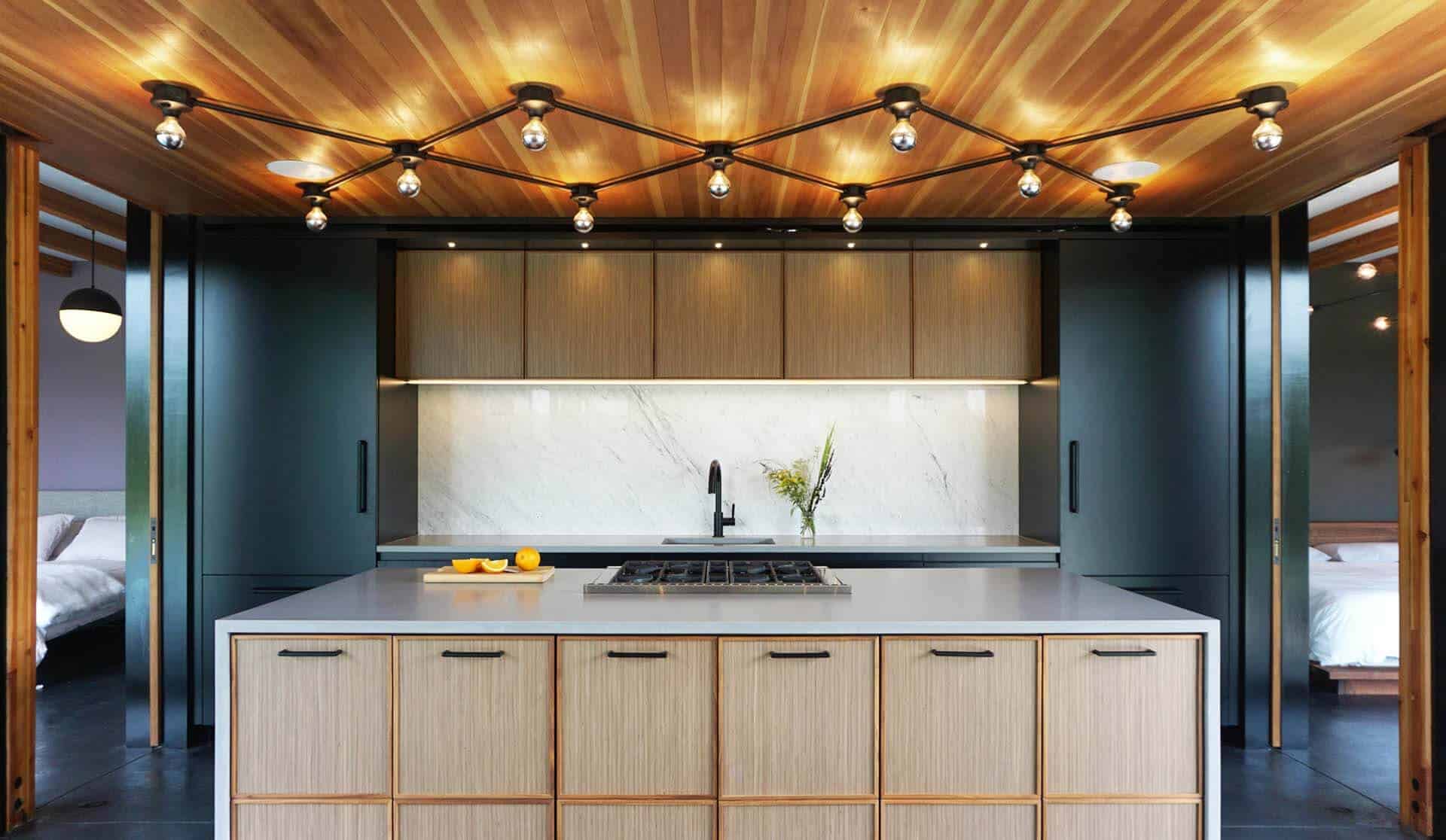 Mid-century modern kitchen features distinctive cabinets of natural walnut quarter-sawn veneer trimmed with walnut solid stock.