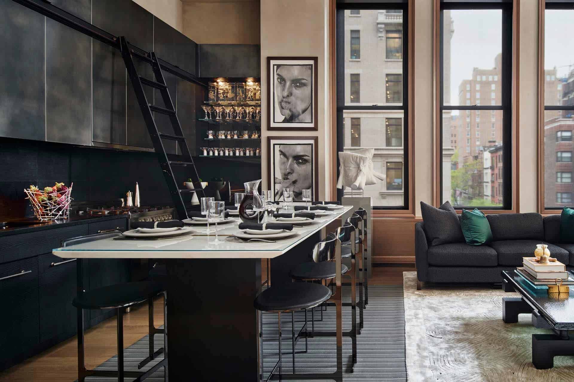 Contemporary NYC kitchen features dark ceiling level cabinets, glass shelving with a mirror backing and large island.
