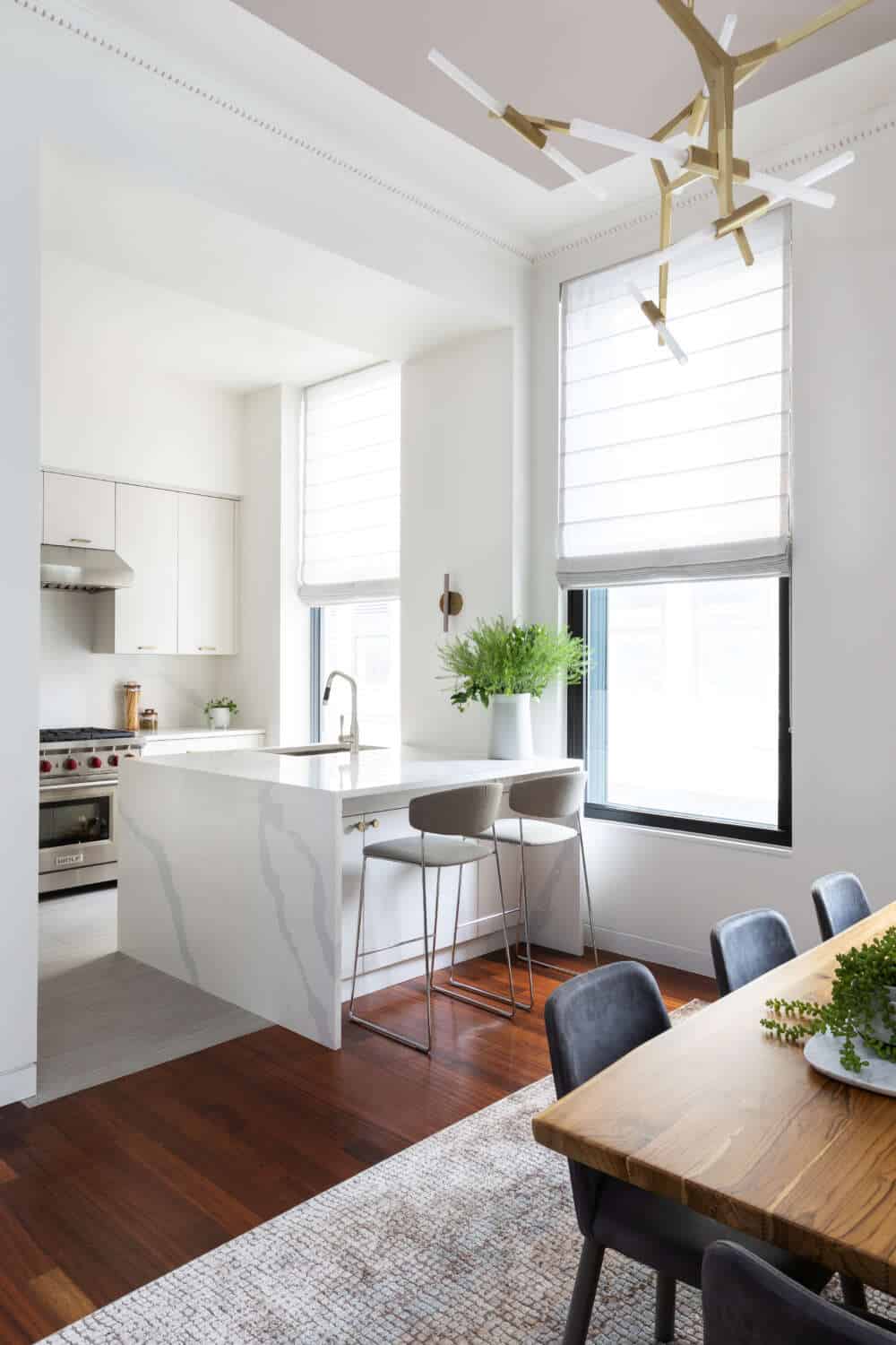 Tribeca loft kitchen features island with waterfall Silestone countertop and Bilotta frameless Copenhagen cabinetry.