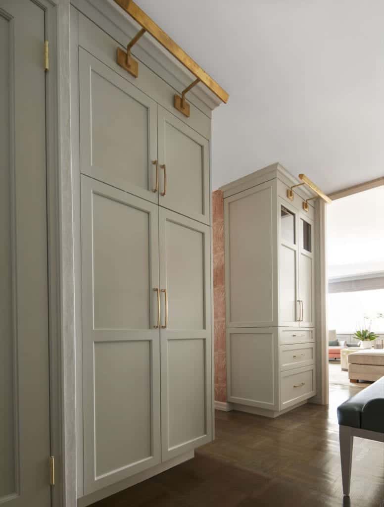 Floor to ceiling Bilotta Metropolitan cabinetry features burnished brass hardware.