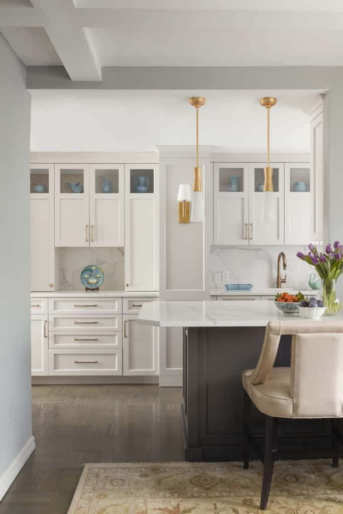 Bilotta cabinetry in Balboa Mist with burnished brass accents and quartz peninsula.
