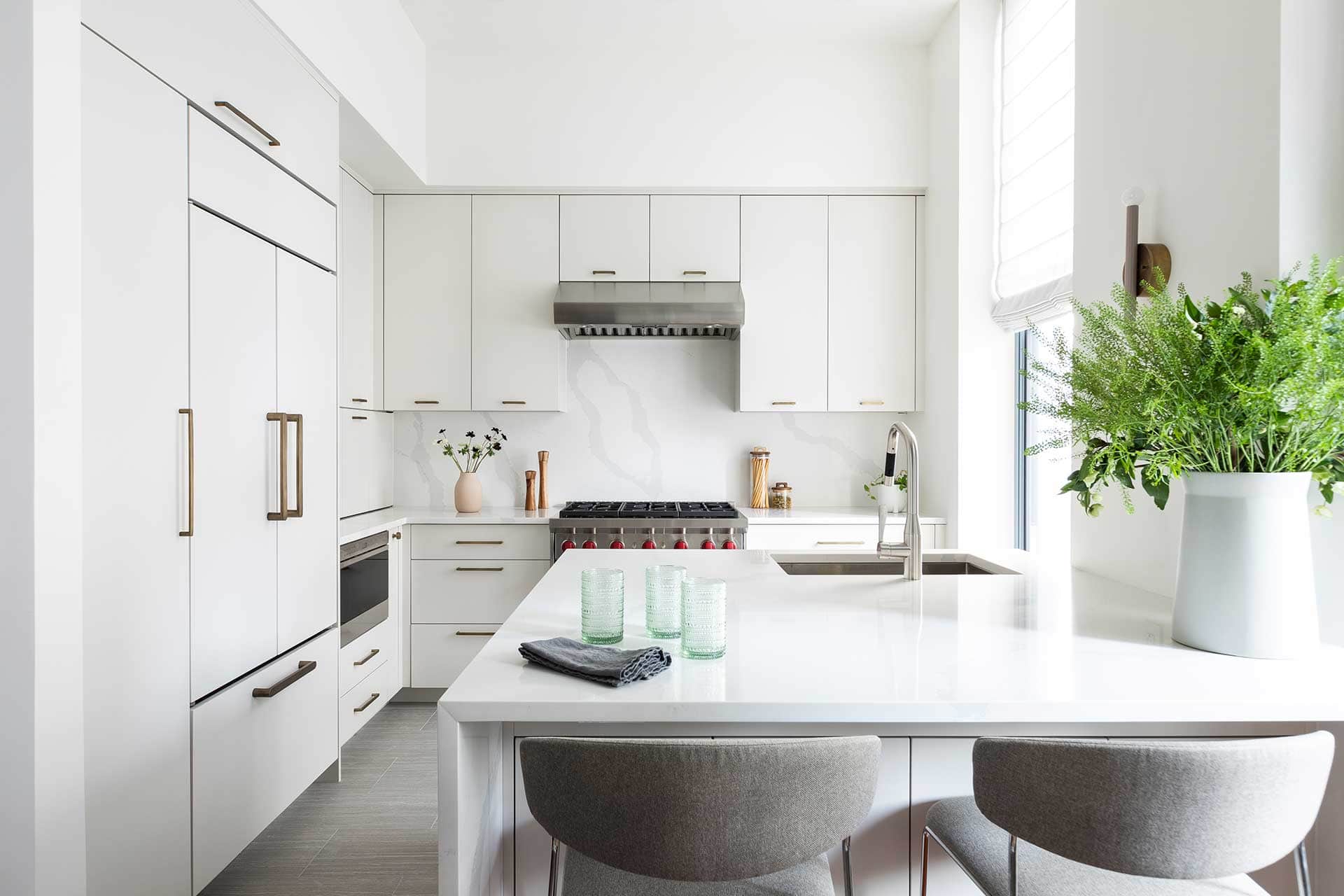 Contemporary all-white Bilotta NYC loft kitchen features durable, easy to clean, low maintenance materials.