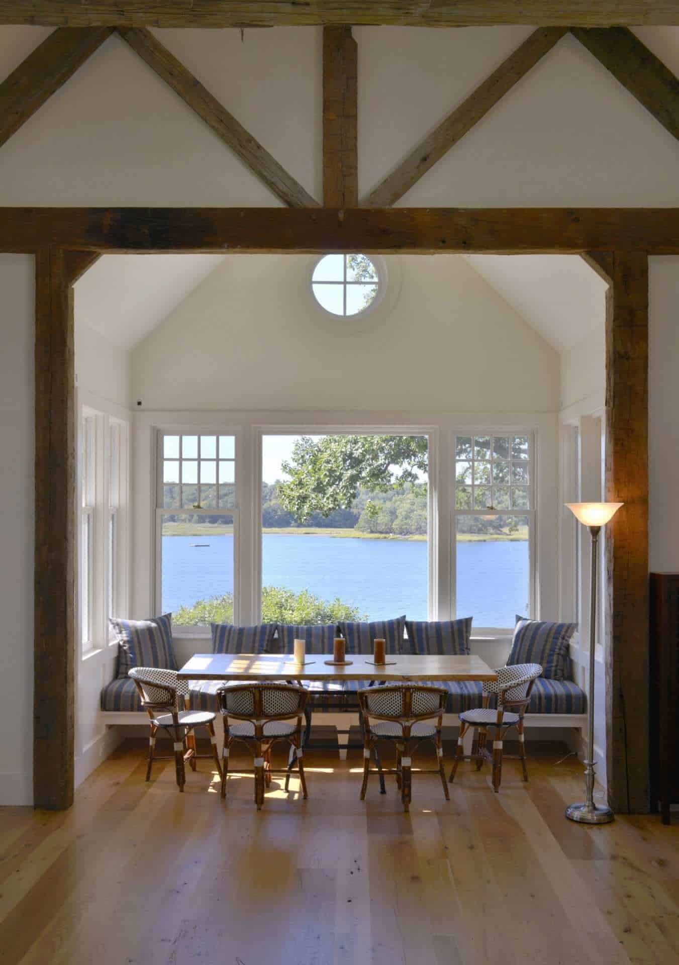 Crisp classic kitchen features decorative exposed beams.