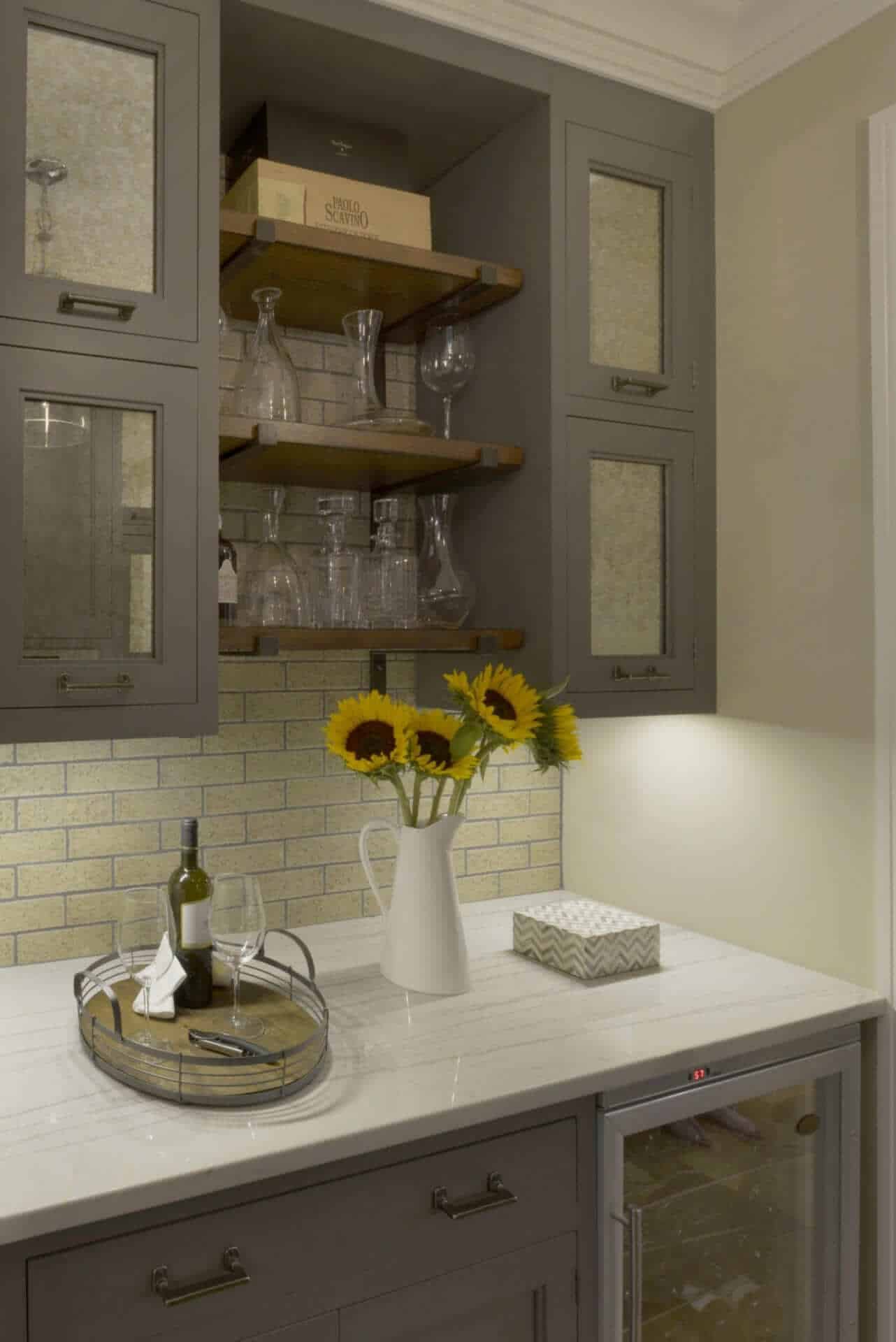 Butler area features open wood shelving with exposed iron hardware and Bilotta grey cabinets with antique glass doors.
