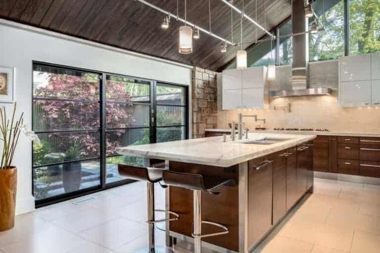 Contemporary kitchen combines glass and stainless elements with Artcraft horizontal grain quarter sawn oak cabinets