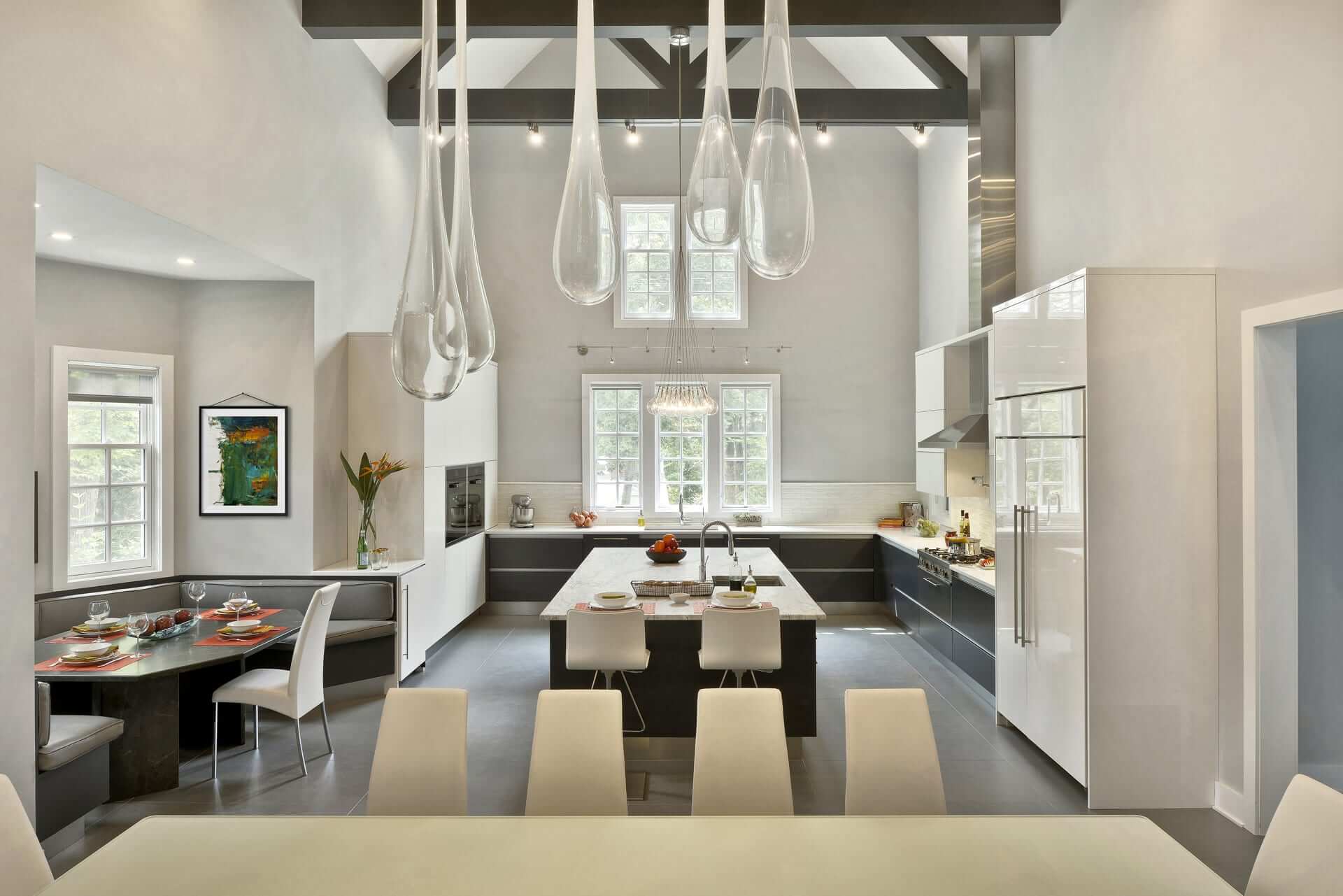 Contemporary Chester, NJ kitchen with soaring ceiling features frameless Artcraft Cabinetry in both high-gloss white finish and dark grey-stained oak.