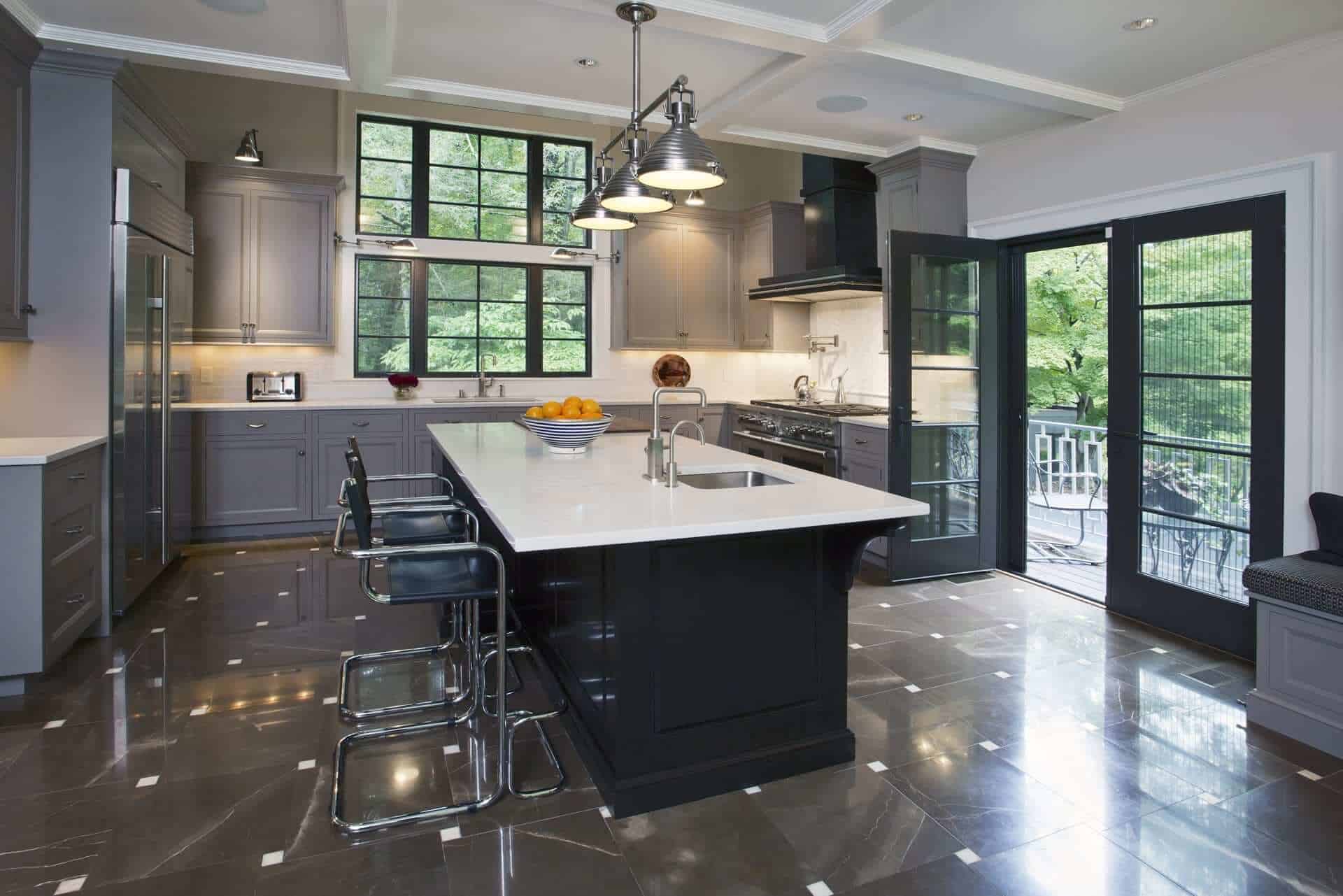 Kitchen in Yorktown NY features Bilotta gray-painted cabinetry, large center island and custom Rangecraft madison hood with dark antique steel finish.